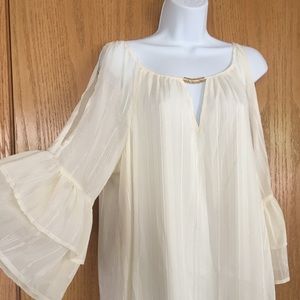 Ivory lined cold shoulder blouse.